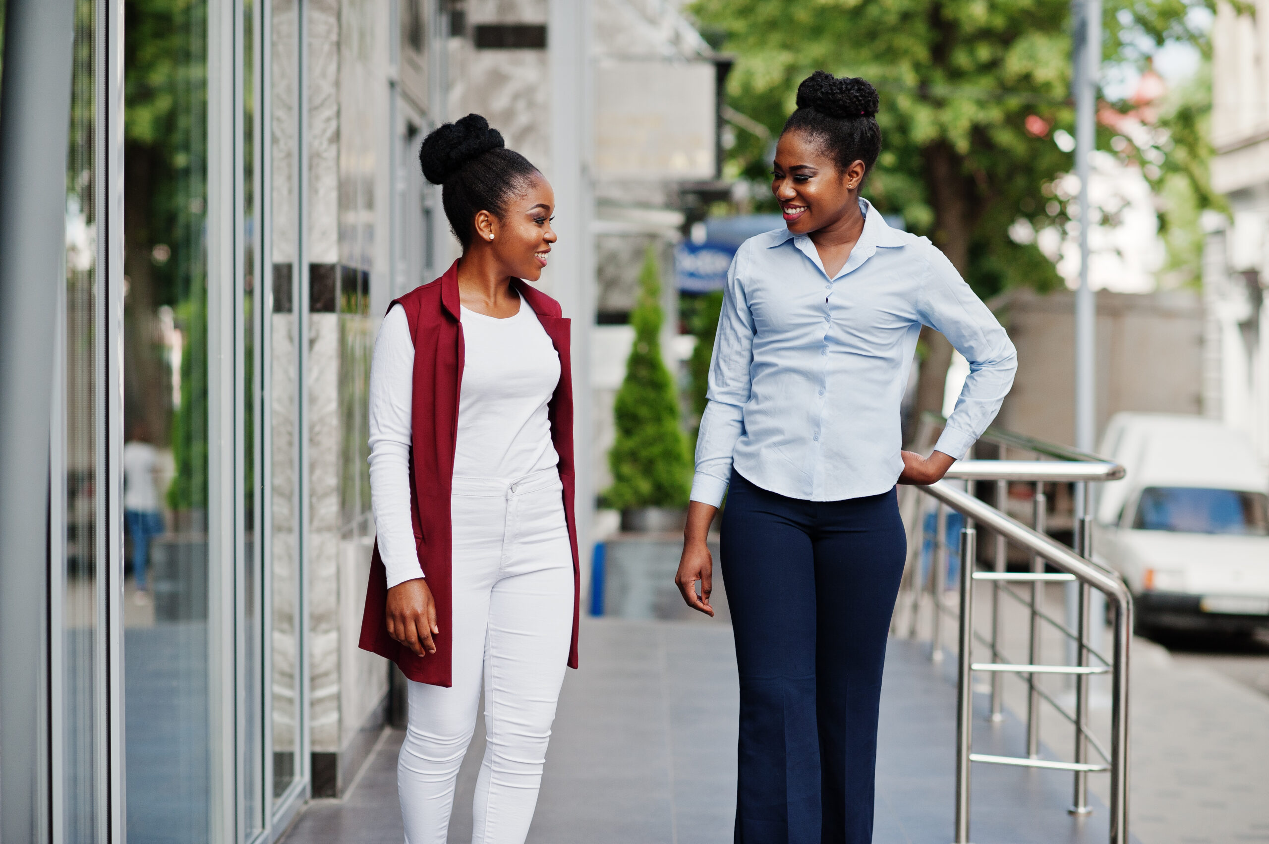 Two stylish african american girls friends posed outdoor of stee