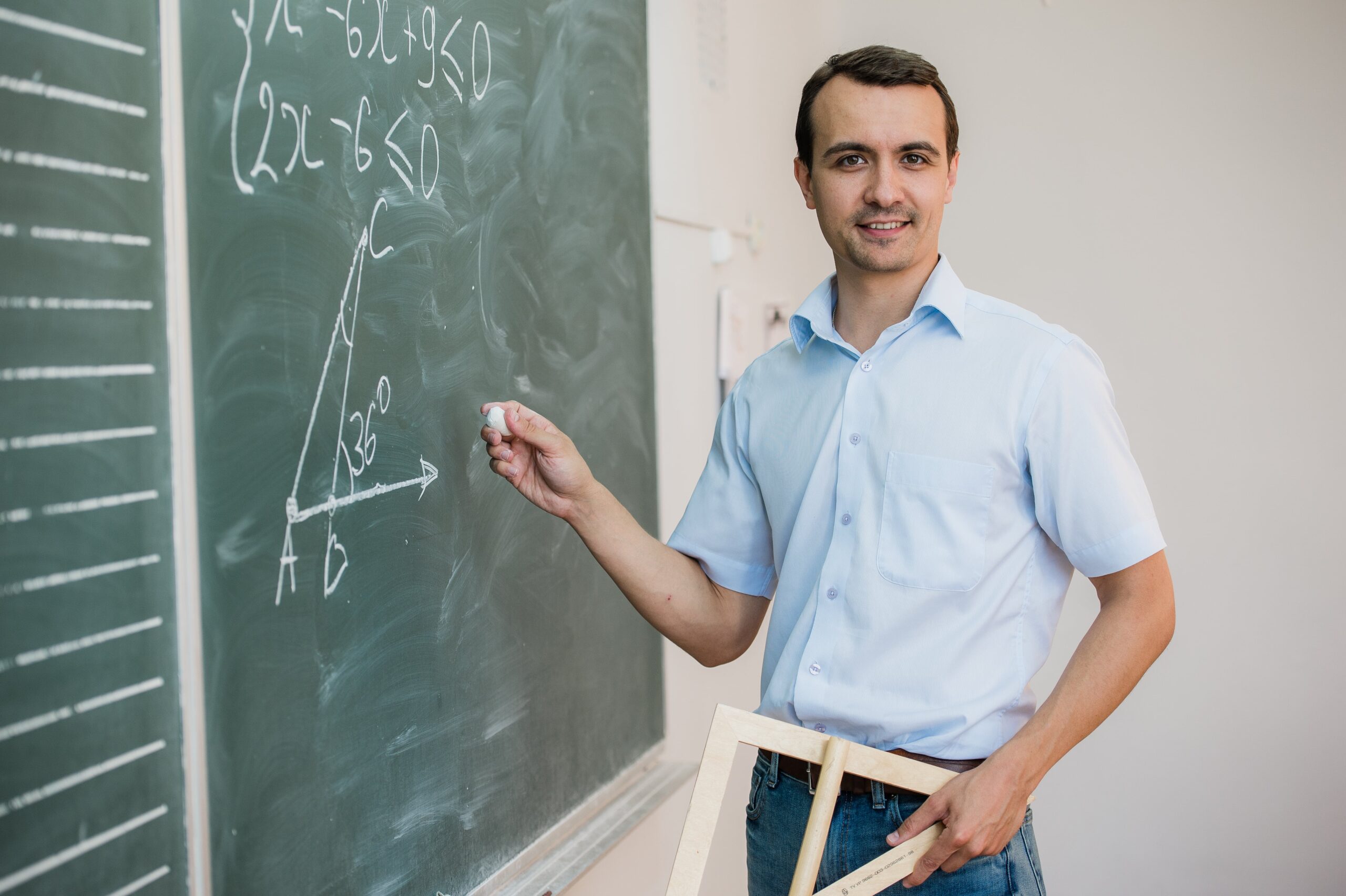 young-teacher-or-student-holding-triangle-pointing-2024-11-03-00-44-52-utc-min (1)